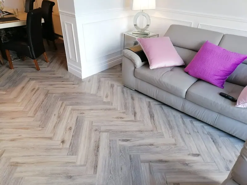 Pale grey herringbone floor in a bright living room
